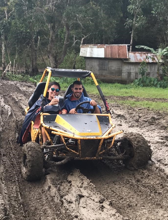 Nuno and friend driving a cart in muddy roads